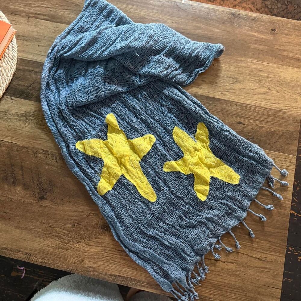 Blue knit scarf with yellow stars